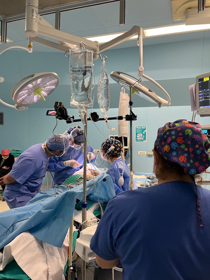 Surgical team focused on patient in operating room, ensuring meticulous care.